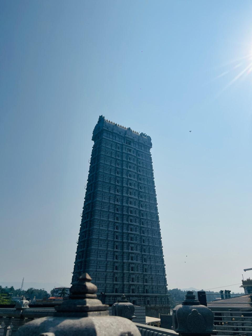 The carved entrance tower of Murudeshwara Temple against a blue sky
